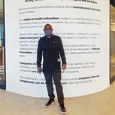 Derrick Coleman in front of GHJ Diversity Wall